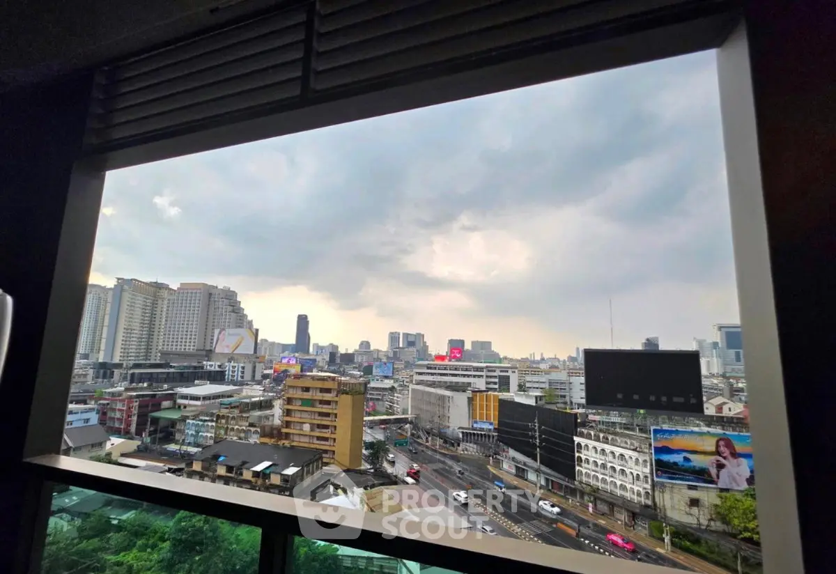 Stunning cityscape view from a high-rise building window, showcasing urban skyline and bustling streets.