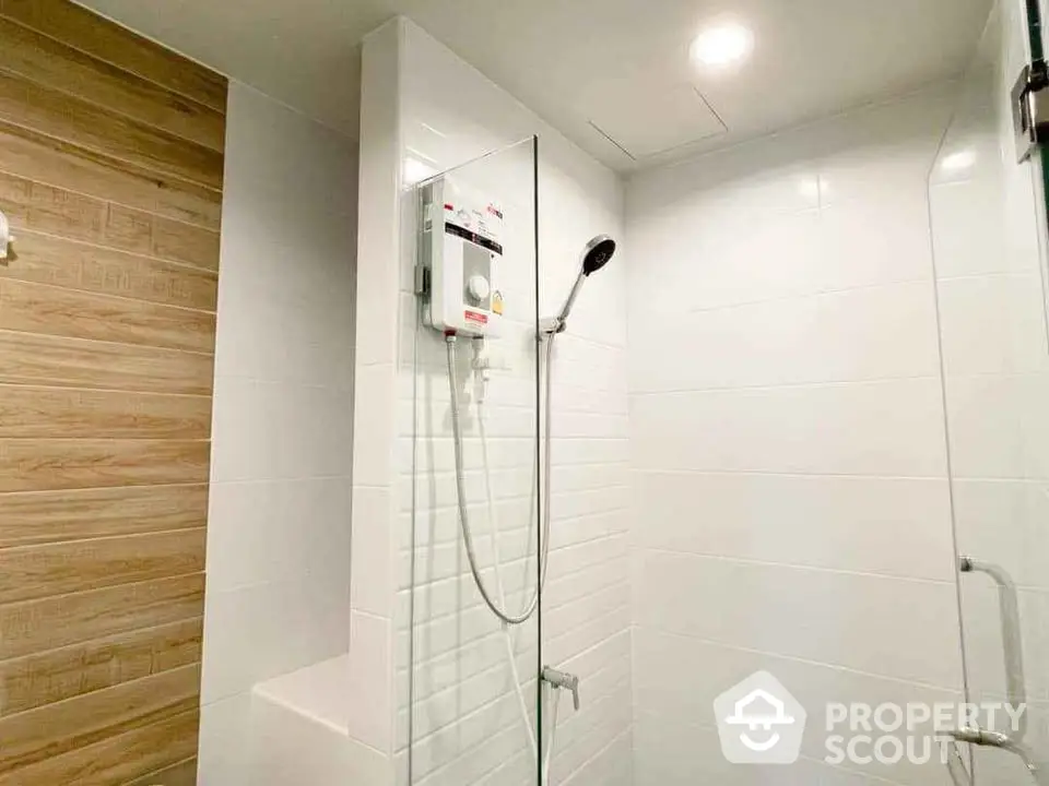 Modern bathroom with sleek shower design and wood accent wall