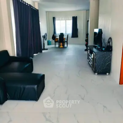 Spacious living room with modern decor and large windows for natural light.