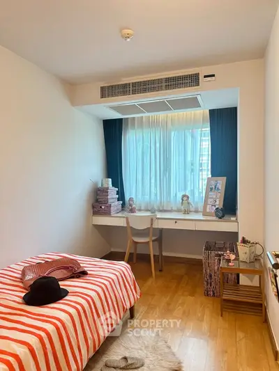 Cozy bedroom with study area and natural light