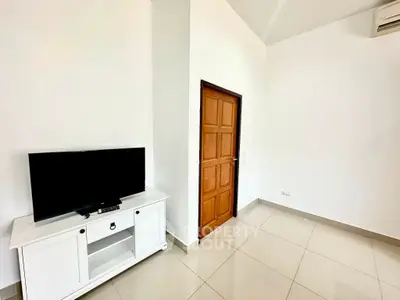 Spacious minimalist living room with sleek TV stand and modern decor