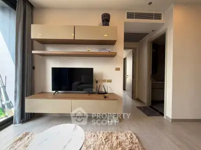 Modern living room with sleek TV unit and stylish decor in a contemporary apartment.