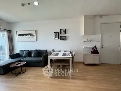 Modern living room with stylish decor and dining area in a cozy apartment.