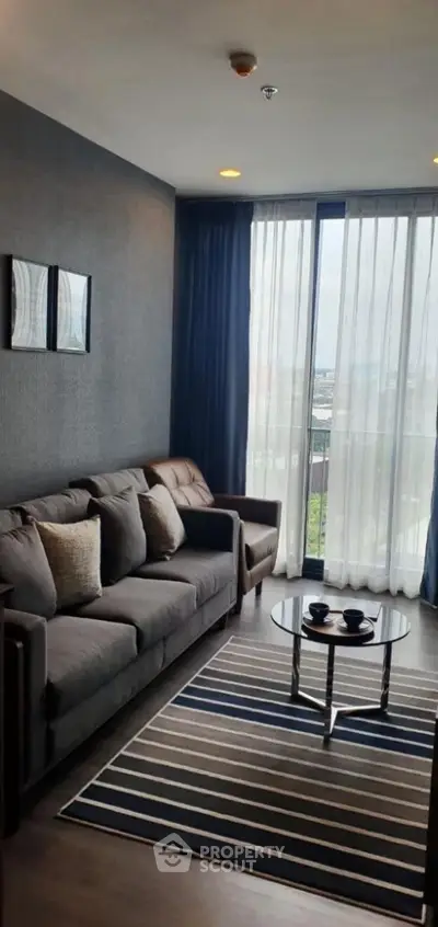 Modern living room with stylish decor and large window view