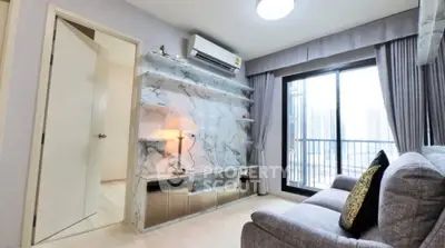 Modern living room with marble accent wall and balcony view in high-rise apartment