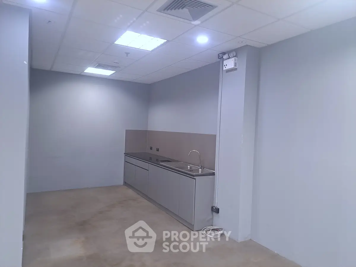 Modern minimalist kitchen with sleek cabinetry and neutral tones in a spacious layout.
