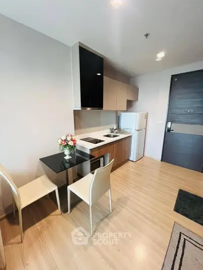Modern compact kitchen with dining area in stylish apartment