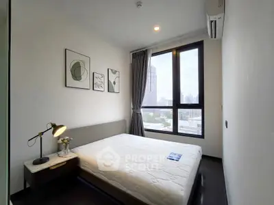 Modern bedroom with large window and city view, featuring stylish decor and natural light.