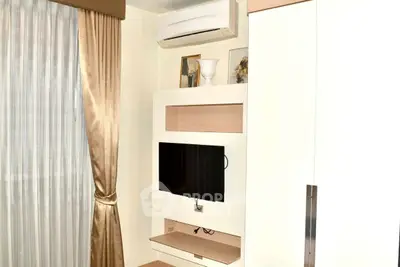 Modern living room with air conditioning and wall-mounted TV