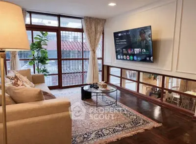 Spacious living room with large windows and modern decor
