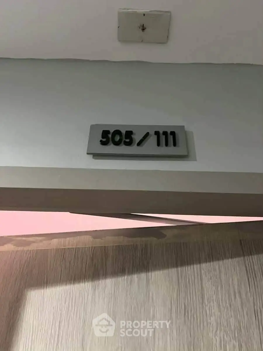 Modern apartment door with unit number 505/111, showcasing sleek design and contemporary style.