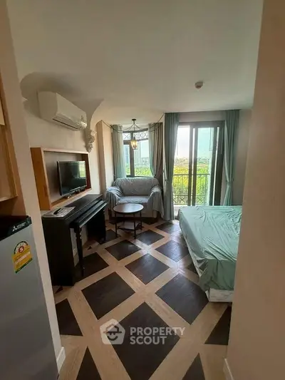 Charming studio apartment with modern decor and balcony view, perfect for urban living.