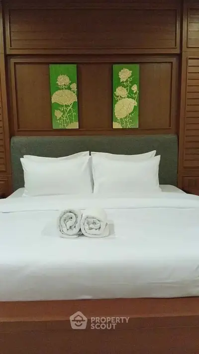 Luxurious bedroom with elegant wooden paneling and plush bedding