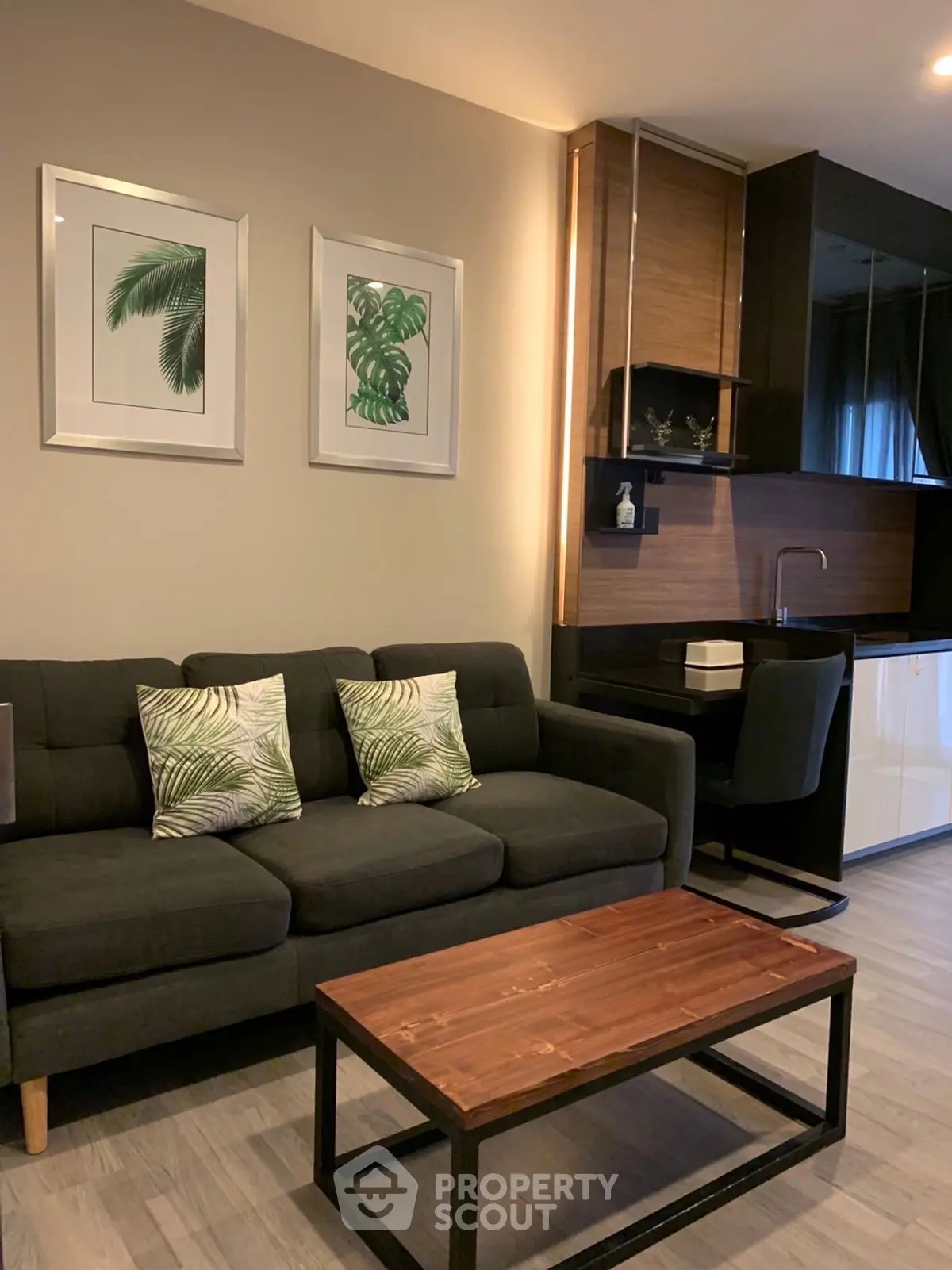 Stylish modern living room with dark sofa and wooden accents, perfect for urban living.