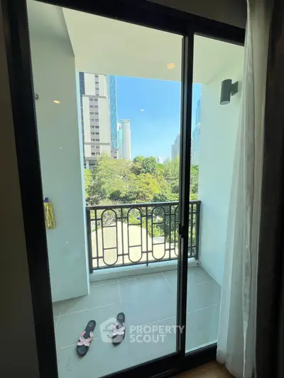 Charming balcony with city view and sliding glass door in modern apartment