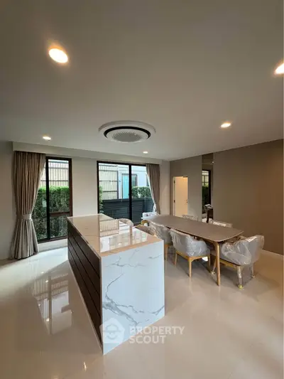 Spacious modern living room with elegant dining area and large windows