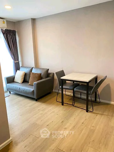 Cozy living room with modern sofa and dining table, perfect for urban living.