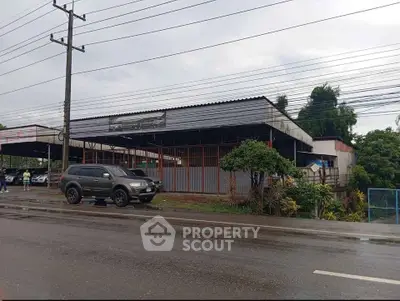 Commercial property with ample parking space and roadside access, ideal for business opportunities.