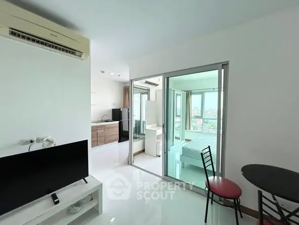 Modern open-plan apartment with sleek kitchen and bright living area