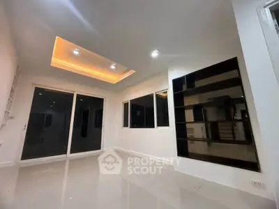 Modern living room with recessed lighting and large windows, perfect for natural light and contemporary living.