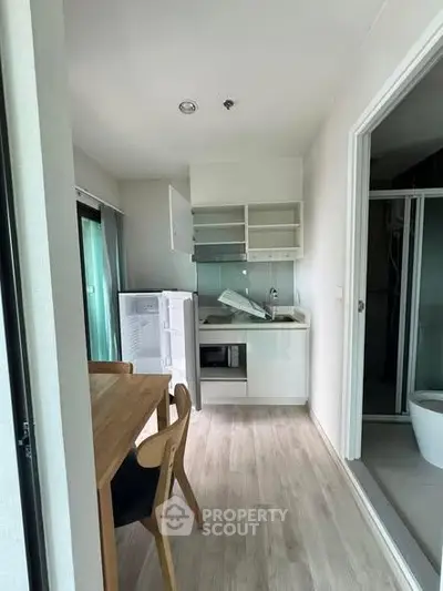 Compact kitchen with dining area in modern apartment