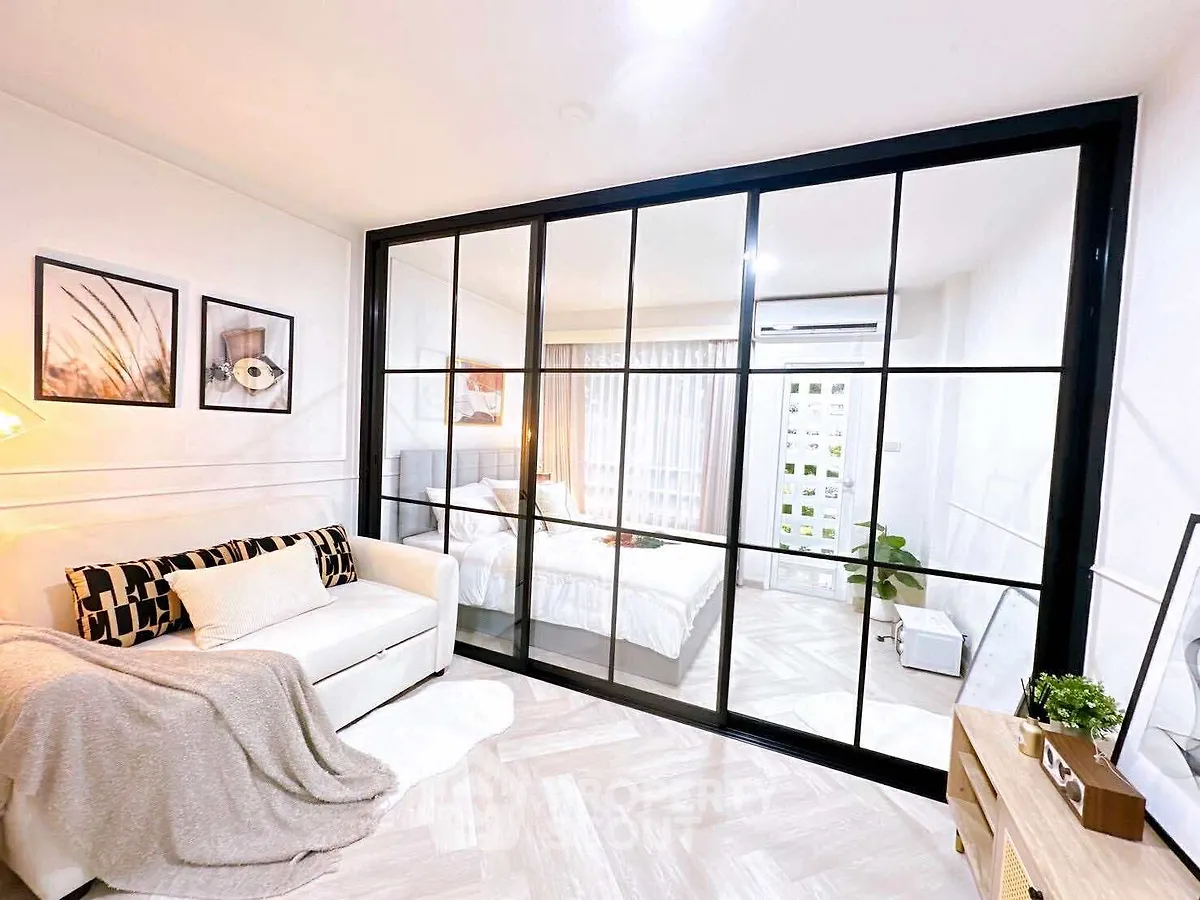 Modern living room with glass partition and cozy decor