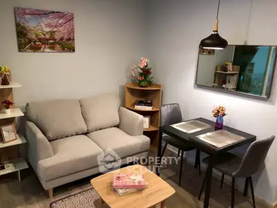 Cozy living room with modern decor, featuring a comfortable sofa, dining table, and stylish lighting.