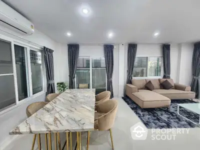 Modern living room with marble dining table and cozy seating area