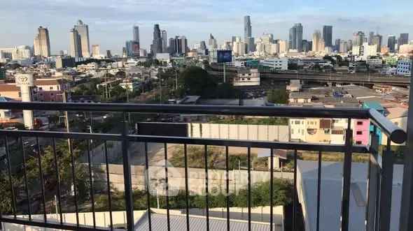 Stunning cityscape view from a high-rise balcony overlooking urban skyline.