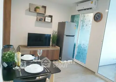 Modern living room with dining area, featuring sleek furniture and air conditioning.