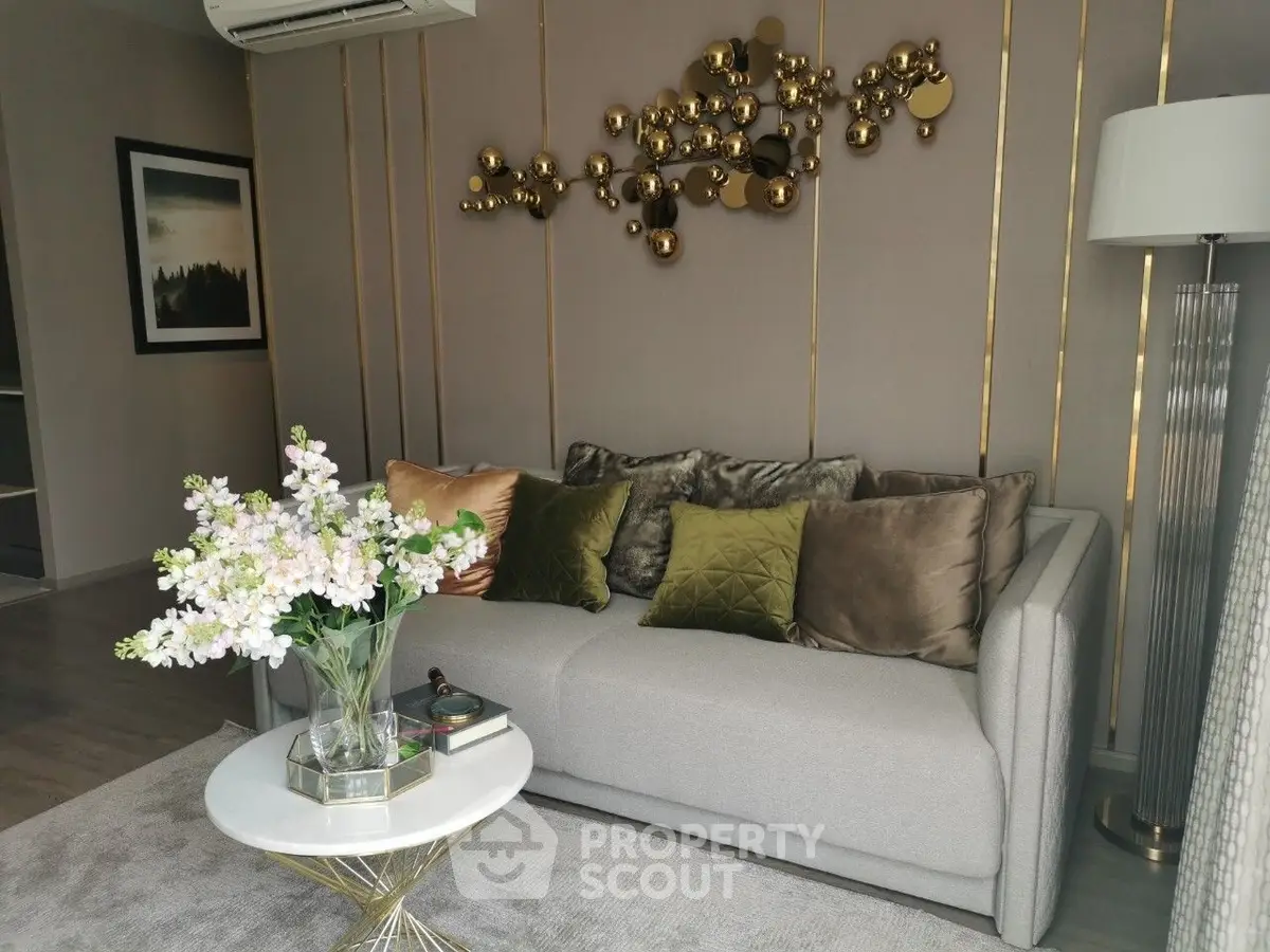 Elegant living room with modern decor, plush sofa, and stylish wall art, perfect for cozy relaxation.