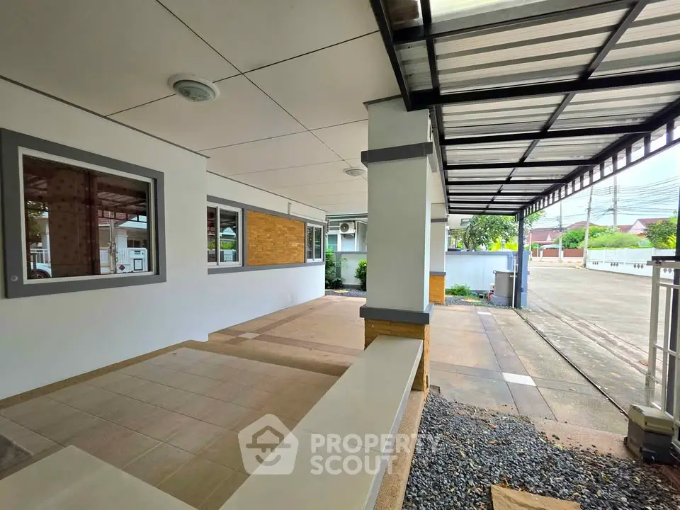 Spacious covered patio area with modern design and ample natural light, perfect for outdoor relaxation.