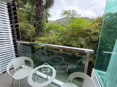Charming balcony with lush greenery view, perfect for relaxation and enjoying nature.