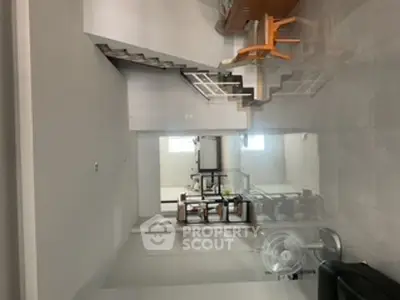 Spacious modern living room with sleek staircase and minimalist design