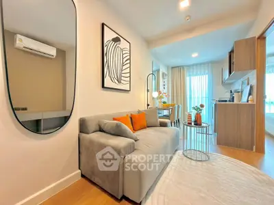 Modern living room with stylish decor and open kitchen layout in a cozy apartment.