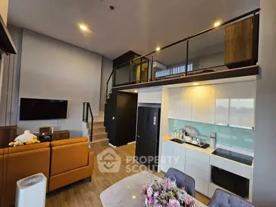 Modern loft apartment with open kitchen and stylish living area, featuring a mezzanine level and elegant decor.
