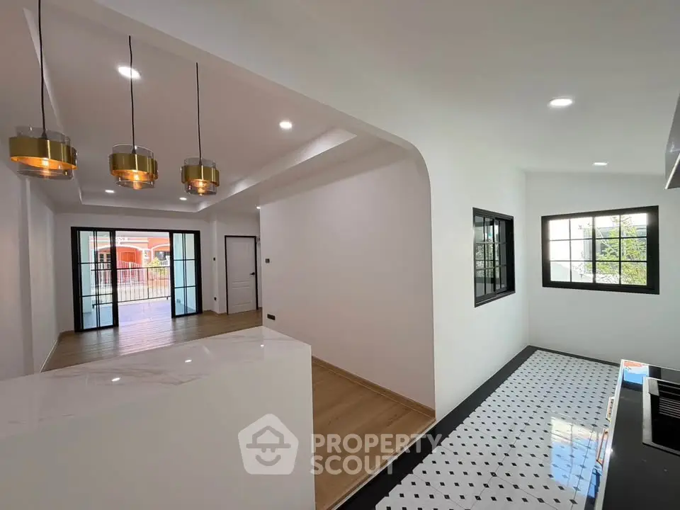 Modern open layout with stylish lighting and wooden flooring