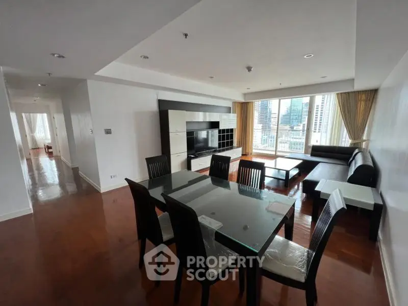 Spacious modern living room with city view and elegant dining area