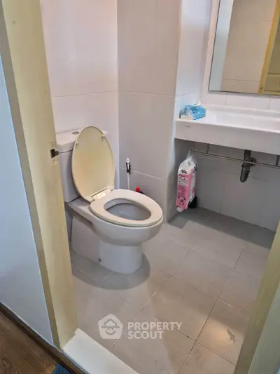 Modern bathroom with sleek fixtures and neutral tiles, perfect for a contemporary home.