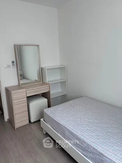 Cozy bedroom with minimalist furniture and natural light, perfect for a serene living experience.