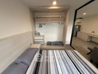 Modern bedroom with stylish storage and open view to living area
