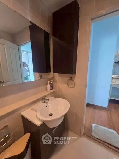 Modern bathroom with sleek sink and storage cabinets