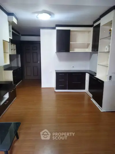 Spacious living room with modern built-in cabinets and wooden flooring