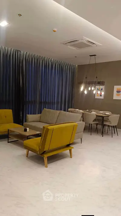 Stylish modern living room with elegant dining area and chic lighting