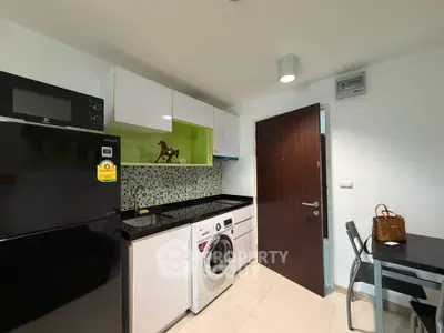 Modern kitchen with sleek appliances and stylish mosaic backsplash