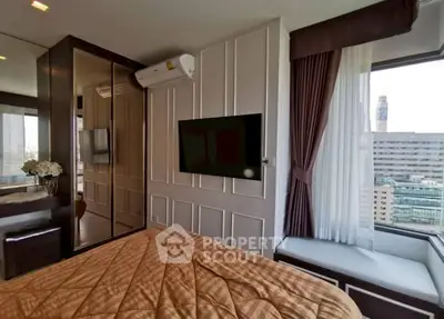 Luxurious bedroom with city view, featuring modern decor and wall-mounted TV, perfect for urban living.