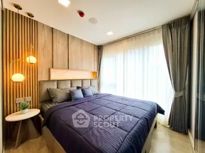 Modern bedroom with elegant decor and large window for natural light