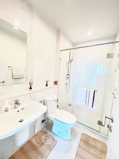 Modern bathroom with sleek design, glass shower, and elegant fixtures.