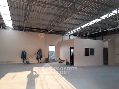 Spacious industrial-style warehouse with high ceilings and ample natural light.