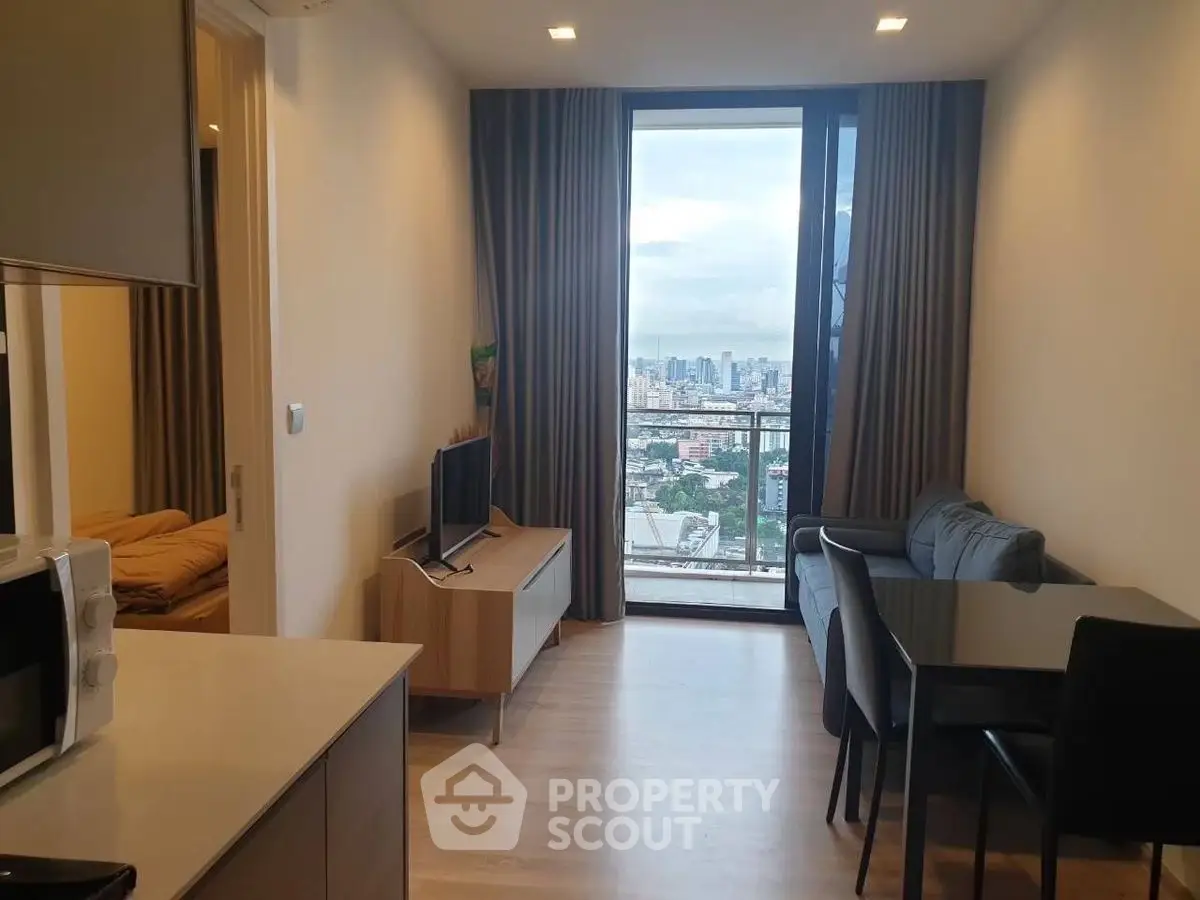 Modern apartment living room with city view, stylish furniture, and open layout.